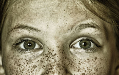Cropped portrait of girl with freckles