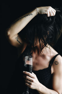 Midsection of woman drinking glass