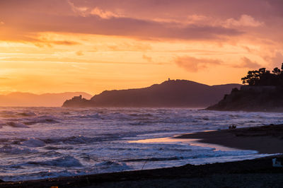 Scenic view of beach against sky during sunset