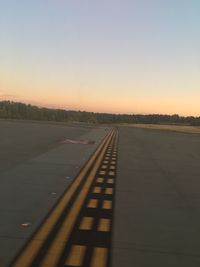 Road against clear sky during sunset