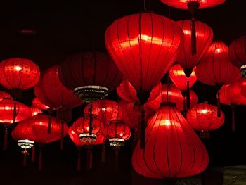 Low angle view of illuminated lanterns hanging at night