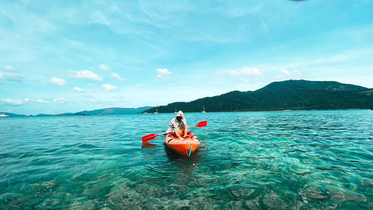 PEOPLE ON BOAT AGAINST SEA