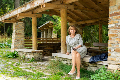 Portrait of woman sitting on bench