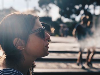 Portrait of young man looking away outdoors