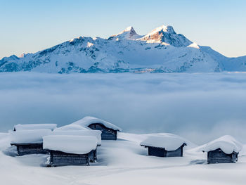 Scenic view of snowcapped mountains against clear sky