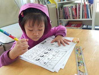 Girl holding book at home