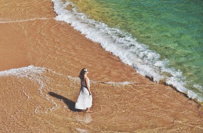 Woman walking on the cala pola beach in costa brava in spain