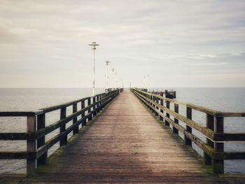 Pier over sea against sky