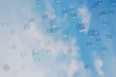 Low angle view of bubbles against sky