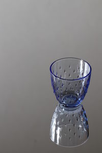 Close-up of glass of water against white background