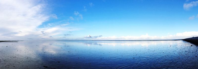 Scenic view of sea against blue sky