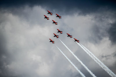 Low angle view of airshow against sky