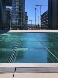 Swimming pool against buildings in city