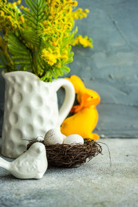 Festive table setting for easter holiday with mimosa flowers and nest