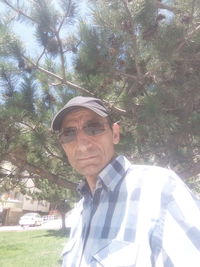 Mid adult man wearing eyeglasses against trees