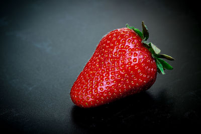 High angle view of strawberries on table against black background