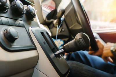 Cropped hand of man driving car