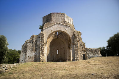 Low angle view of old ruins against clear sky