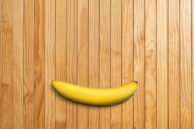 Close-up of yellow fruit on wood