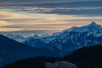 Scenic view of mountains against sky during sunrise