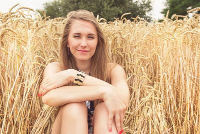 Portrait of smiling young woman in field