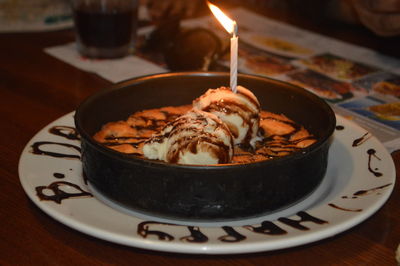 Close-up of candle on dessert