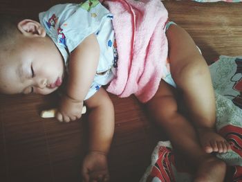 High angle view of baby sleeping on bed at home