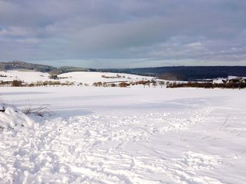 Scenic view of snow covered landscape against sky