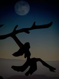 Silhouette of people at beach against sky