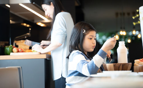 Girl sitting on table at restaurant