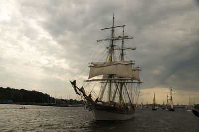 Sailboats moored at harbor