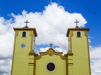 Low angle view of bell tower against sky