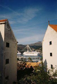 Buildings in town against sky