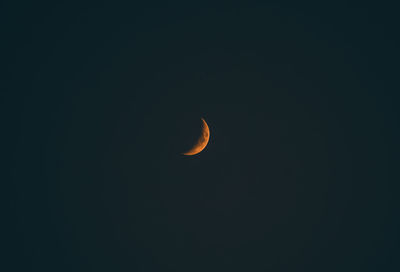 Low angle view of moon against clear sky at night