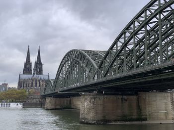 View of bridge over river against cloudy sky