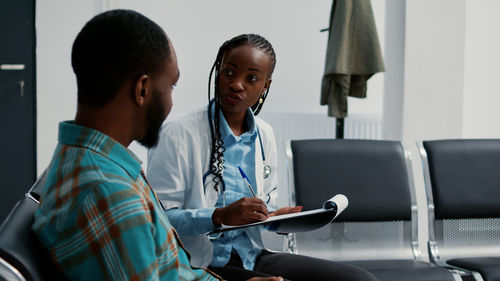 Side view of doctor examining patient in hospital