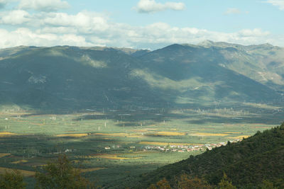 Scenic view of field and mountains against sky