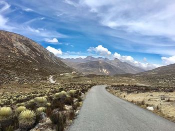 Road amidst mountains against sky