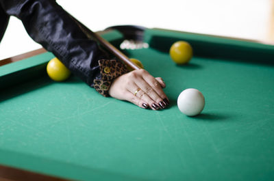 Midsection of person playing with ball on table