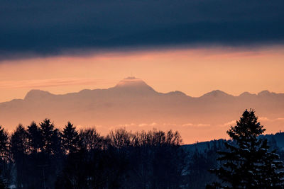 Scenic view of silhouette mountains against sky at sunset