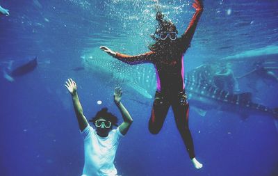 Woman jumping in swimming pool