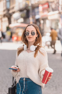 Young woman wearing sunglasses standing outdoors