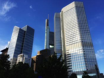 Low angle view of modern building against blue sky