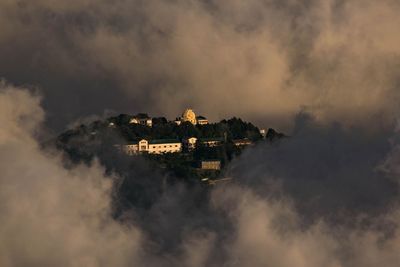 Panoramic view of buildings against sky during foggy weather