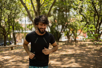 Man running and jogging at a park outdoors. male person workout. feel good, healthy concept. 