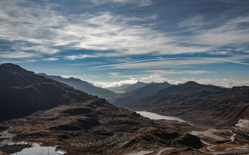 Himalayan breathtaking landscape with bright blue sky and twisty adventurous valley road