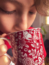 Close-up of a girl holding hat