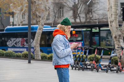 Rear view of woman standing in city