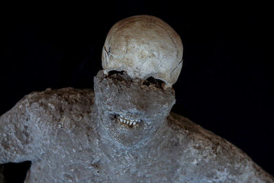 Close-up of human hand against black background