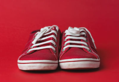 Close-up of shoes against pink background